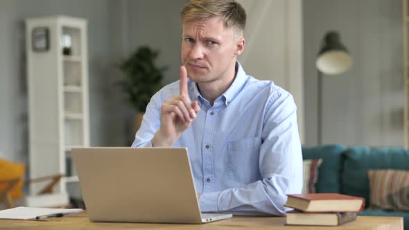 Businessman Rejecting Offer By Waving Finger at Work