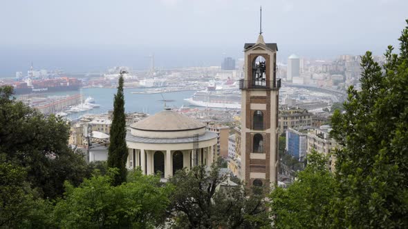 Bell tower and majestic cityscape view with massive harbor of Genoa, Italy