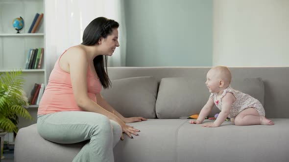 Pregnant Woman Making Baby Girl Laugh Playing With Child Happiness