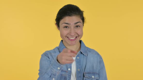 Indian Woman Pointing with Finger, Yellow Background 