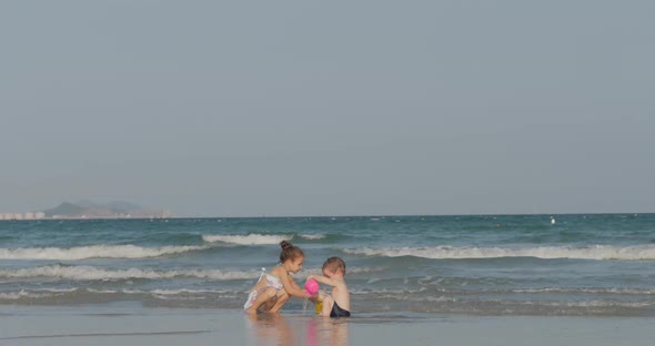 Happy and Carefree Children Playing By the Sea with Sand. Children Playing, Brother and Sister Play