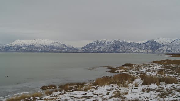 Aerial drone shots of the south end of Utah Lake in the Winter, looking toward the mountains.