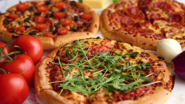 Three American Style Pizzas Served on a Table