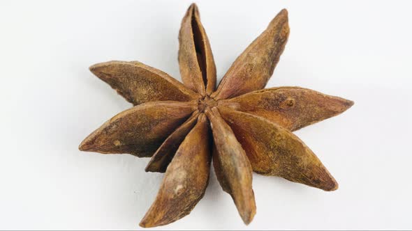 Star Anise, Spice Rotates on the Table on White Background