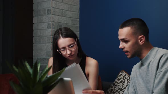 Frustrated Young Adult Man and Woman Feeling Stressed About Doing Paperwork at Home or Office. Angry