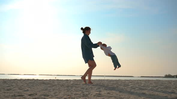 A Caucasian Mother Circles the Child Around Her By the Handles