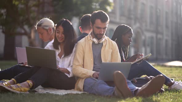 Multiracial Students Preparing for Classes Outdoor