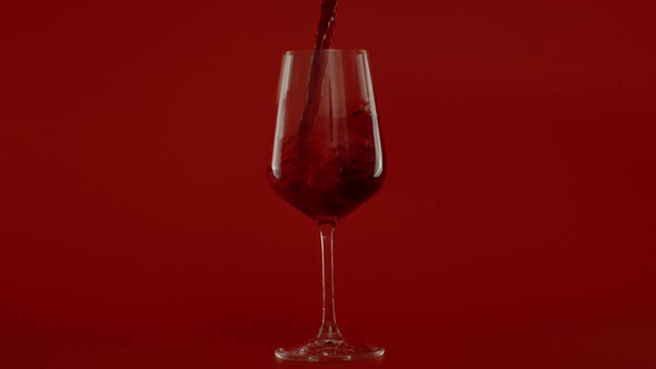 Slow Motion of Pouring Red Wine in Glass at 1000 Fps Red Background