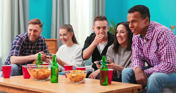 Multiethnic People Celebrate Video Game Victory in Home Living Room