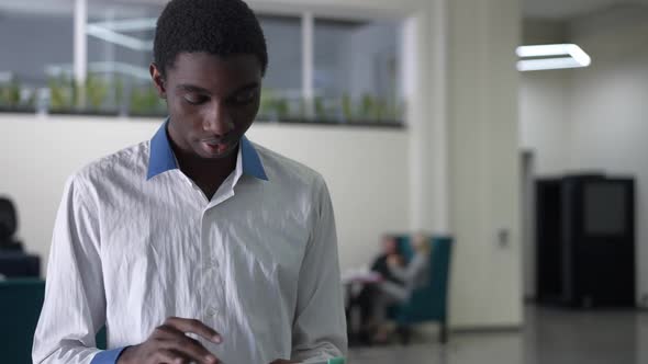 Portrait of Genius African American Young Man Analyzing Emarket on Tablet and Looking at Camera