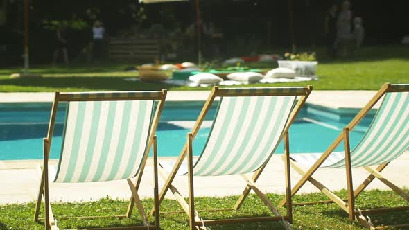 Deckchairs near swimming pool at wedding