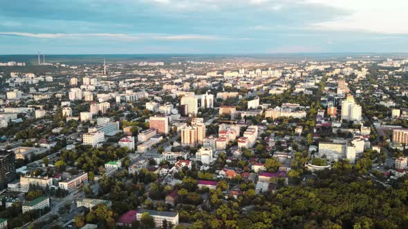 Aerial drone view of Chisinau, Moldova at sunset. Buildings, roads, greenery, cloudy sky