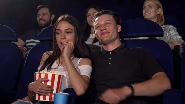 Happy Couple Laughing While Watching Comedy Movie at the Cinema