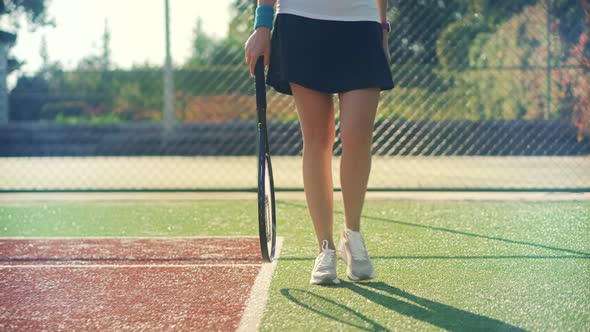 Girl Tennis Player With Racket. Sport Woman In Sportwear Playing Match. Squat Game Ball Practicing.