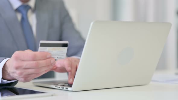 Close Up of Businessman Making Online Payment on Laptop