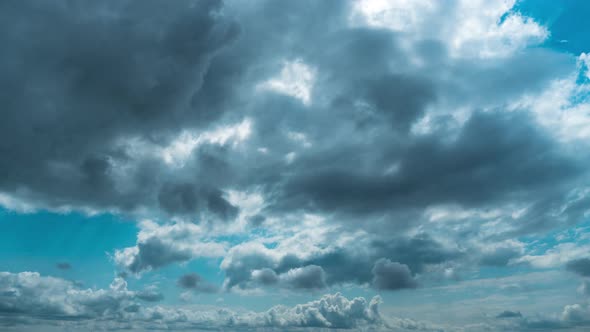 White Fluffy Clouds Slowly Float Through the Blue Daytime Sky Timelapse