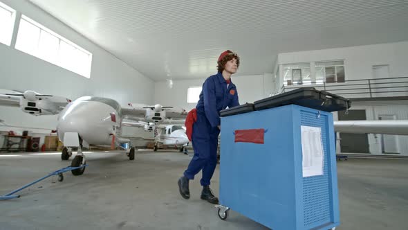 Professional Female Mechanic Working in Aircraft Hangar