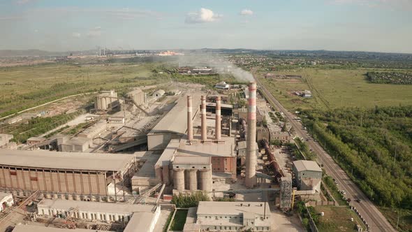 Aerial View of Factory Plant with Smoking Pipes