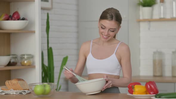 Healthy Woman Enjoying While Cooking in Kitchen