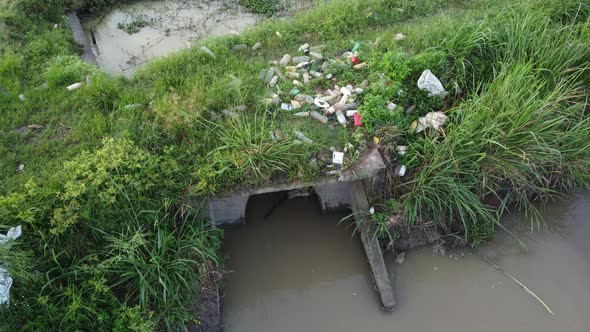 Rubbish thrown beside river bank