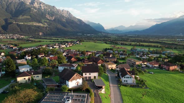 Aerial View of Liechtenstein with Houses on Green Fields in Alps Mountain Valley