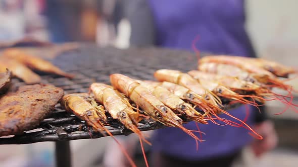 Mediterranean Cuisine. Grilled Fish and Shrimps. Cook Preparing a Meal Outdoors