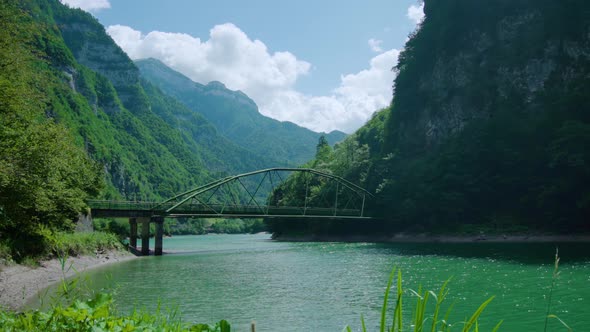 Modern Metal Bridge Over the River in the Mountains