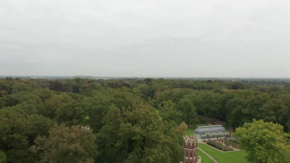 Drone flying backwards and reveal Schaffelaar Castle in Barneveld, the Netherlands