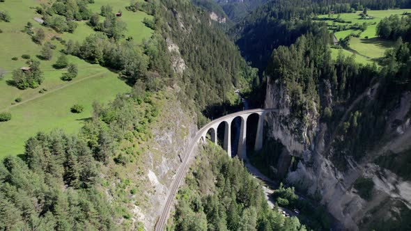 Landwasser Viaduct in Swiss Alps in Summer Aerial View on Green Mountain Valley