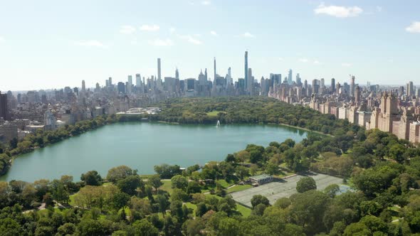 Aerial Drone Flight Forward Dolly Above Green Central Park in Manhattan New York City in Summer