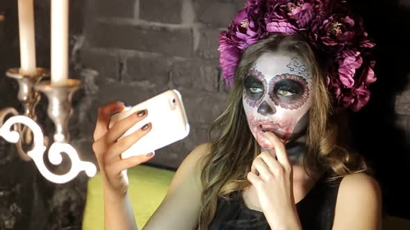Make-up artist make the girl halloween make up in studio.