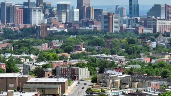 Aerial establishing shot of Baltimore Maryland city skyline in USA. Tilt up from neighborhood homes
