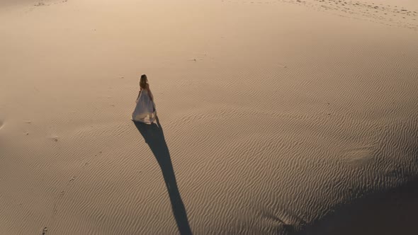 Drone Of Woman In Dress On Sandy Beach