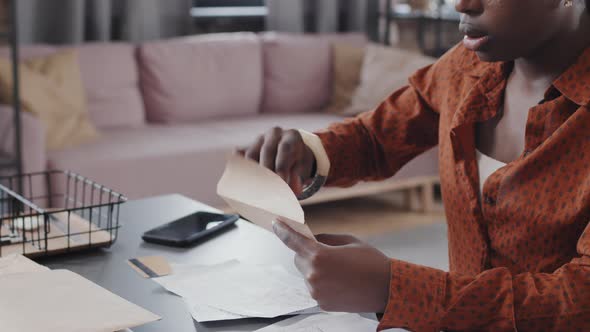 Woman Opening Envelopes with Bills