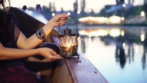 Close Up of a Night Lamp in Female Hands