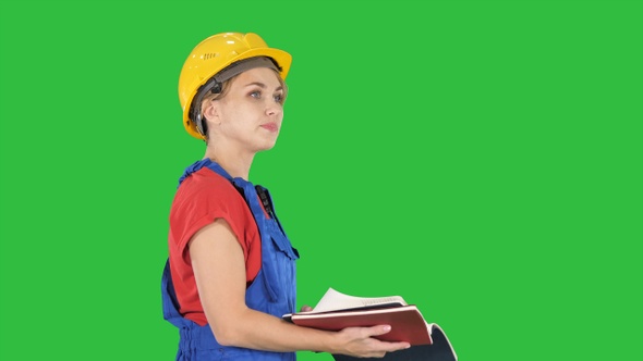 Woman construction worker in hard hat and workwear uniform