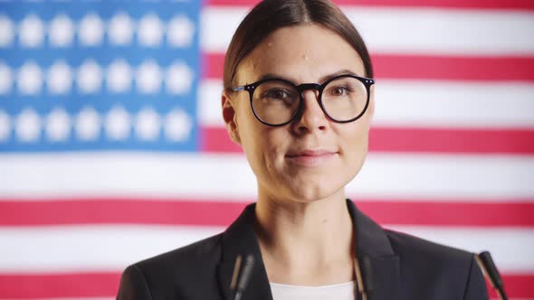 Portrait of Cheerful Female Political Candidate on U,S, Flag