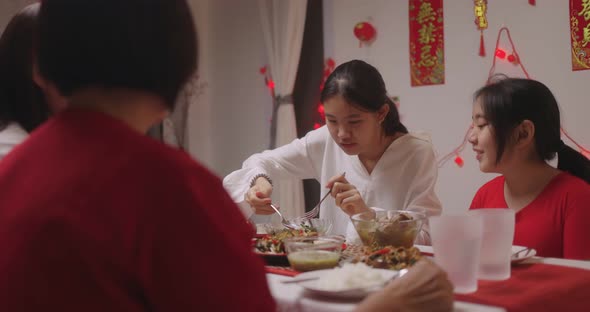 Happy Chinese Family Eating Dinner For Chinese New Year Celebrations.