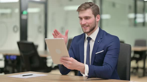 Businessman Making Video Call on Tablet at Work