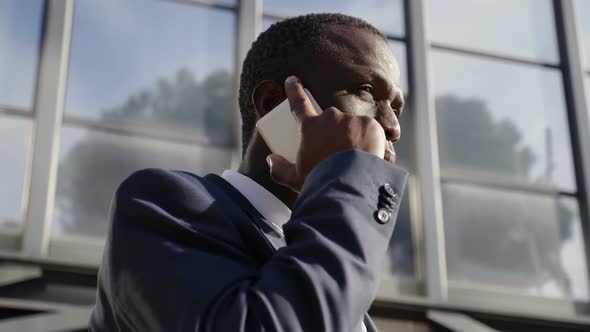 African Businessman on The Street Talking with Smartphone