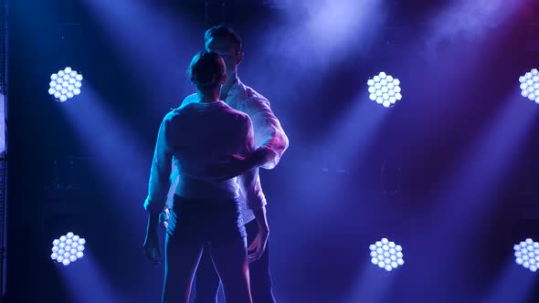 A Man and a Woman Are Emotionally Dancing a Modern, Contemporary Ballet Dance. Shot in a Dark Studio