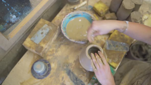 High Angle View of Woman's Hands Molding Clay on Pottery Wheel