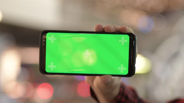 Hands Of Young Man Using Phone In The City At Night