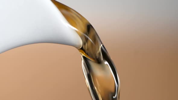 Tea Stream Pouring From White Teapot, Closeup. Slow Motion