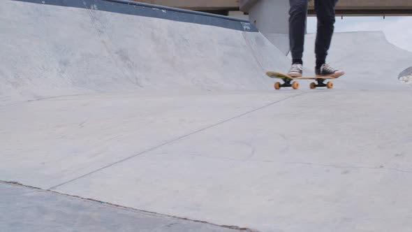 Side View of Male Legs on Skateboard Riding on Ramp
