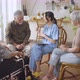 Senior people sit in a circle in a nursing home listen nurse during a group elderly therapy session - VideoHive Item for Sale