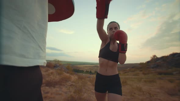 Man in Pawn Help Woman to Practice Blows in Nature View From the Bottom