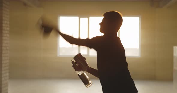 Male Bartender Juggling Bottle and Shaker