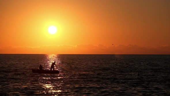 Silhouette of Fishermen at Sunset