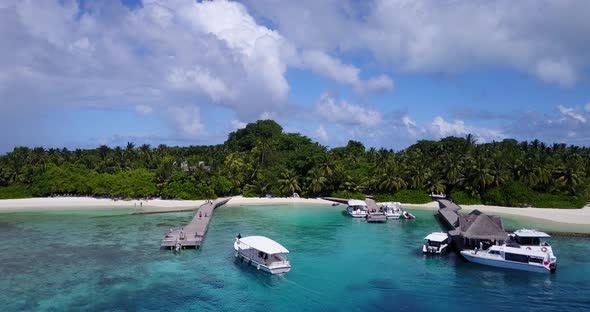 Wide above tourism shot of a white paradise beach and aqua turquoise water background in 4K